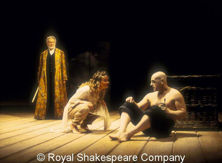 Miranda (Sarah Woodward, centre) reminding Caliban (David Troughton, right) that he attacked her. Prospero (Alec McCowen, left) looks on. (Sam Mendes, 1993)